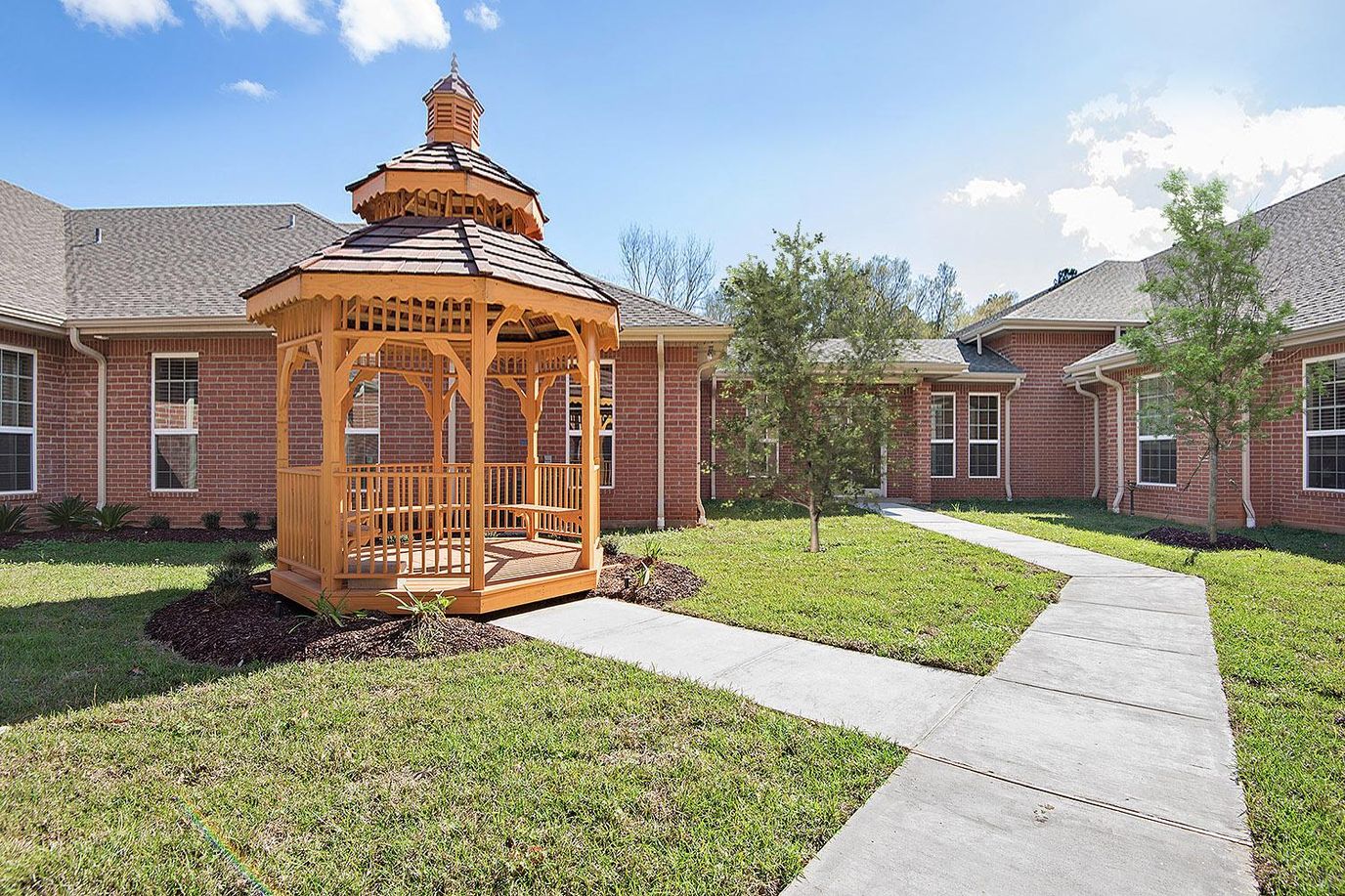 Outdoor gazebo surrounded by a pathway and greenery