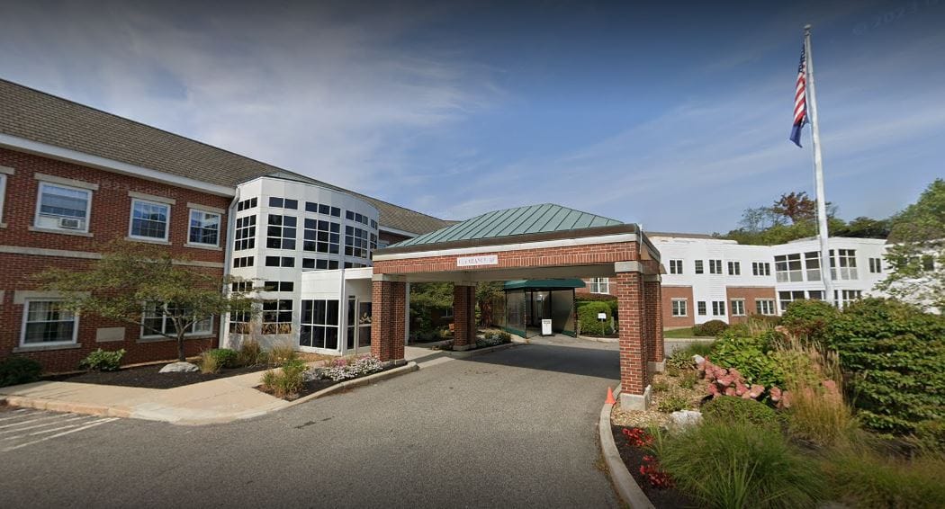 Exterior view of Lunder Memory Care at The Cedars entrance