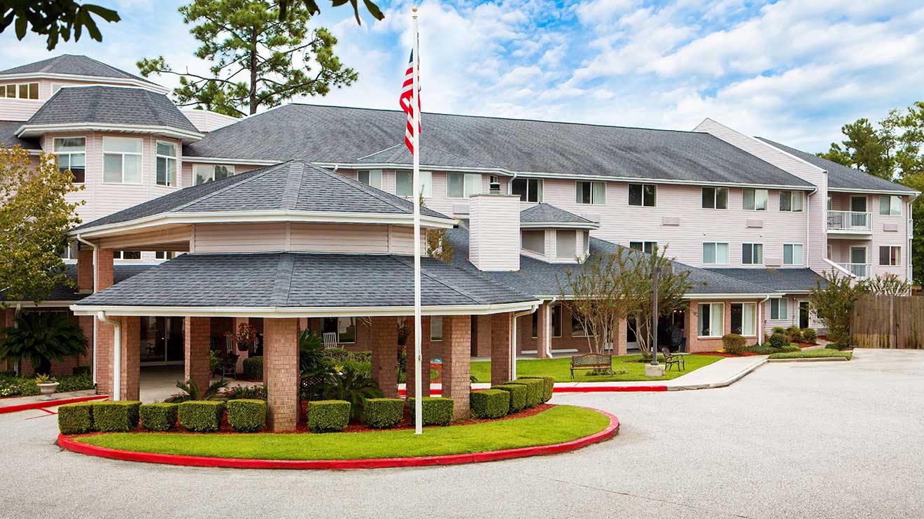 Exterior view of the University Pines facility with landscaping