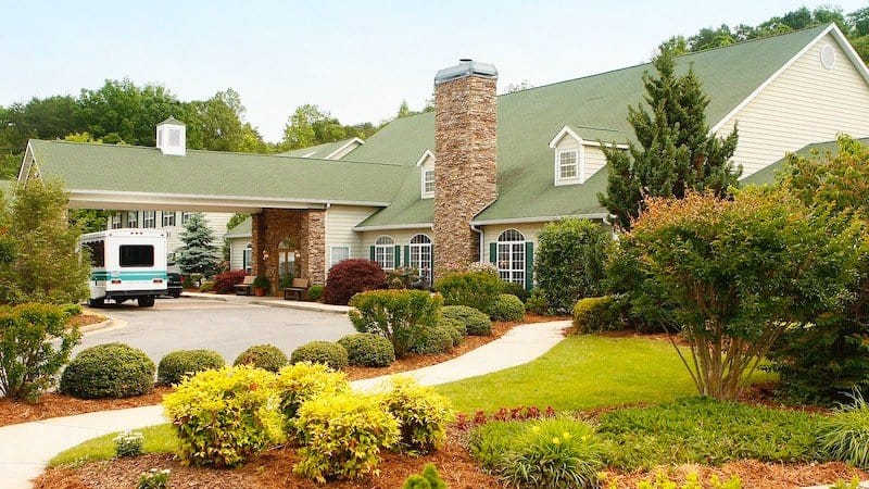 Exterior view of Brasstown Manor Senior Living building and garden.