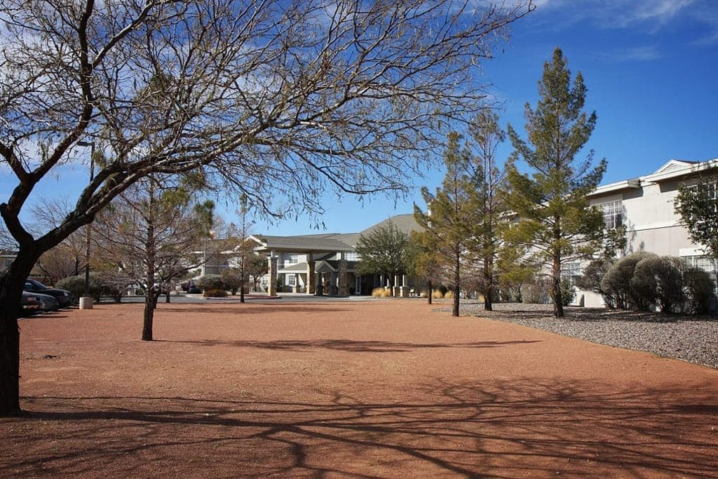 Exterior view of a senior living facility with trees