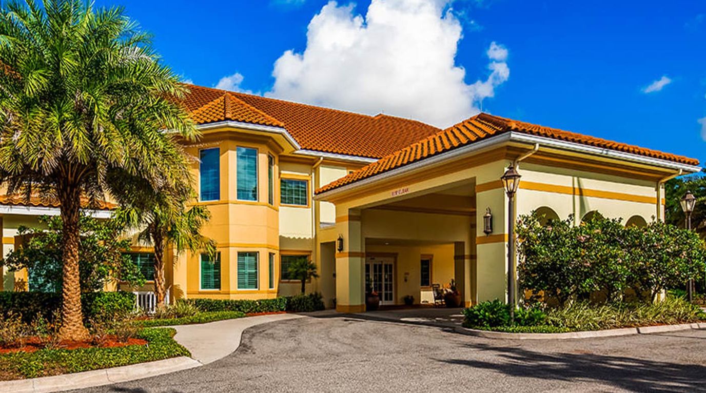 Exterior view of The Windsor at San Pablo with palm trees