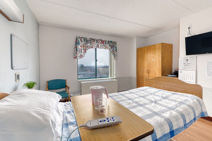 Private resident room with a bed and window view