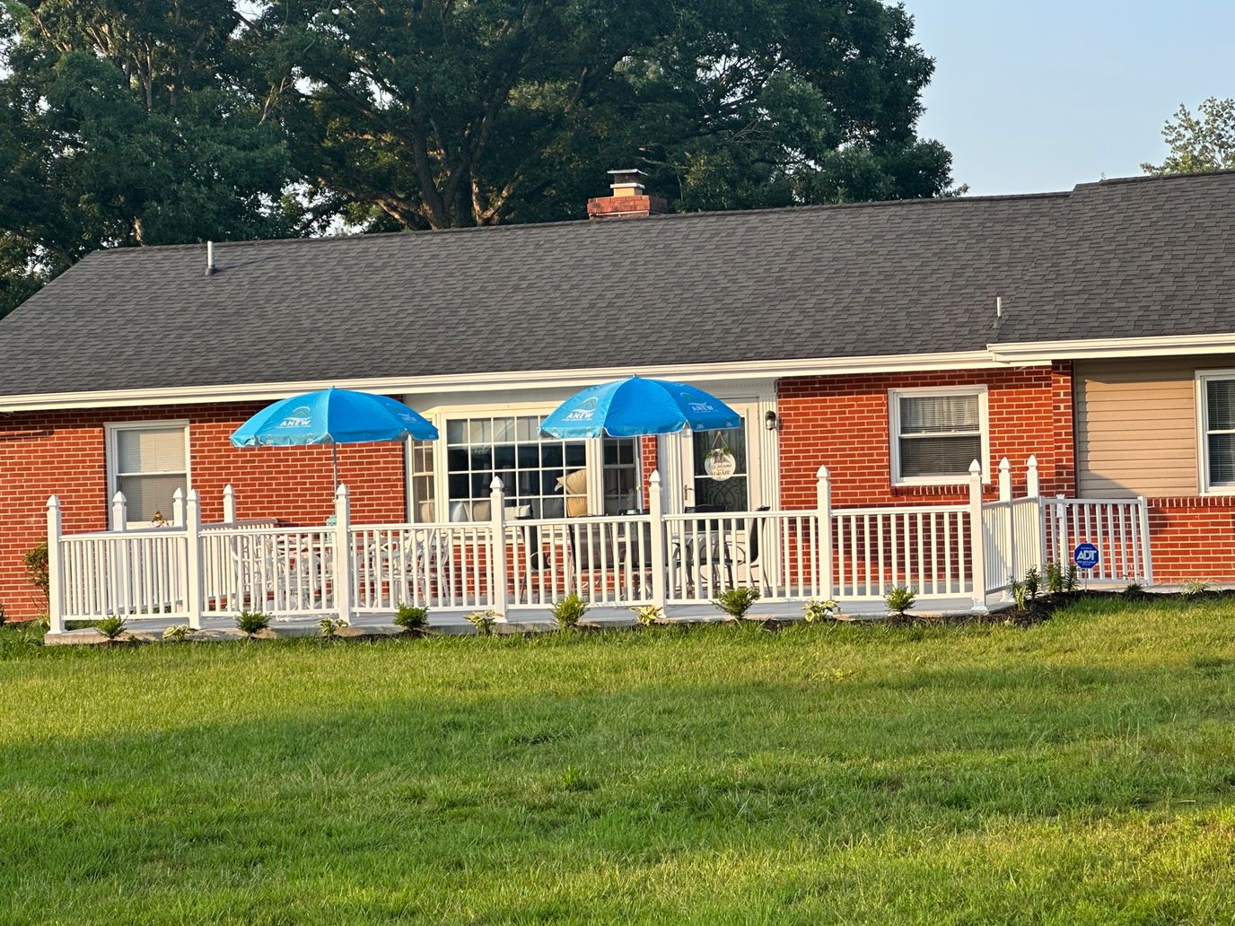 Exterior view of a senior living facility with umbrellas outside