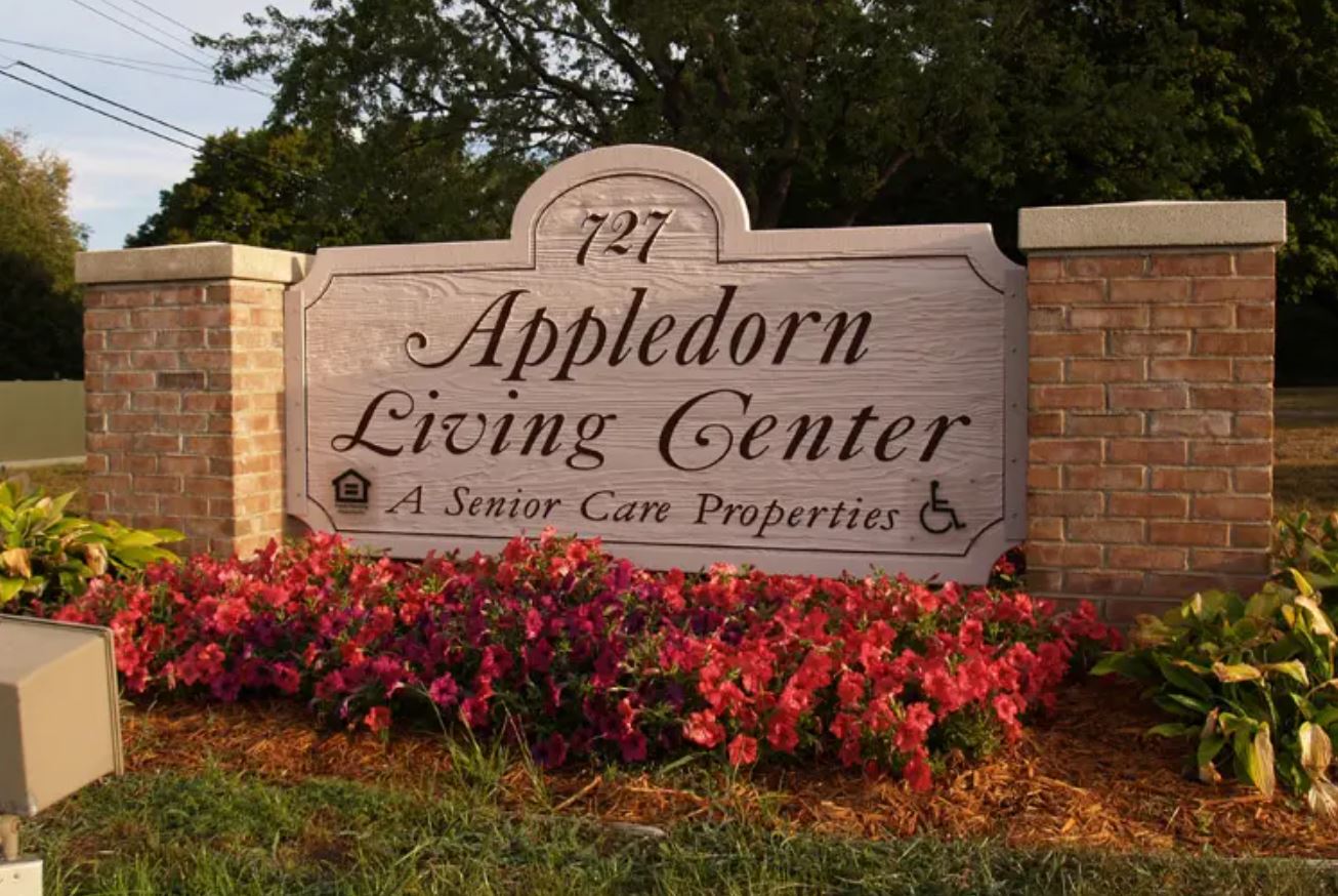 Exterior sign of Appledorn Living Center with flowers