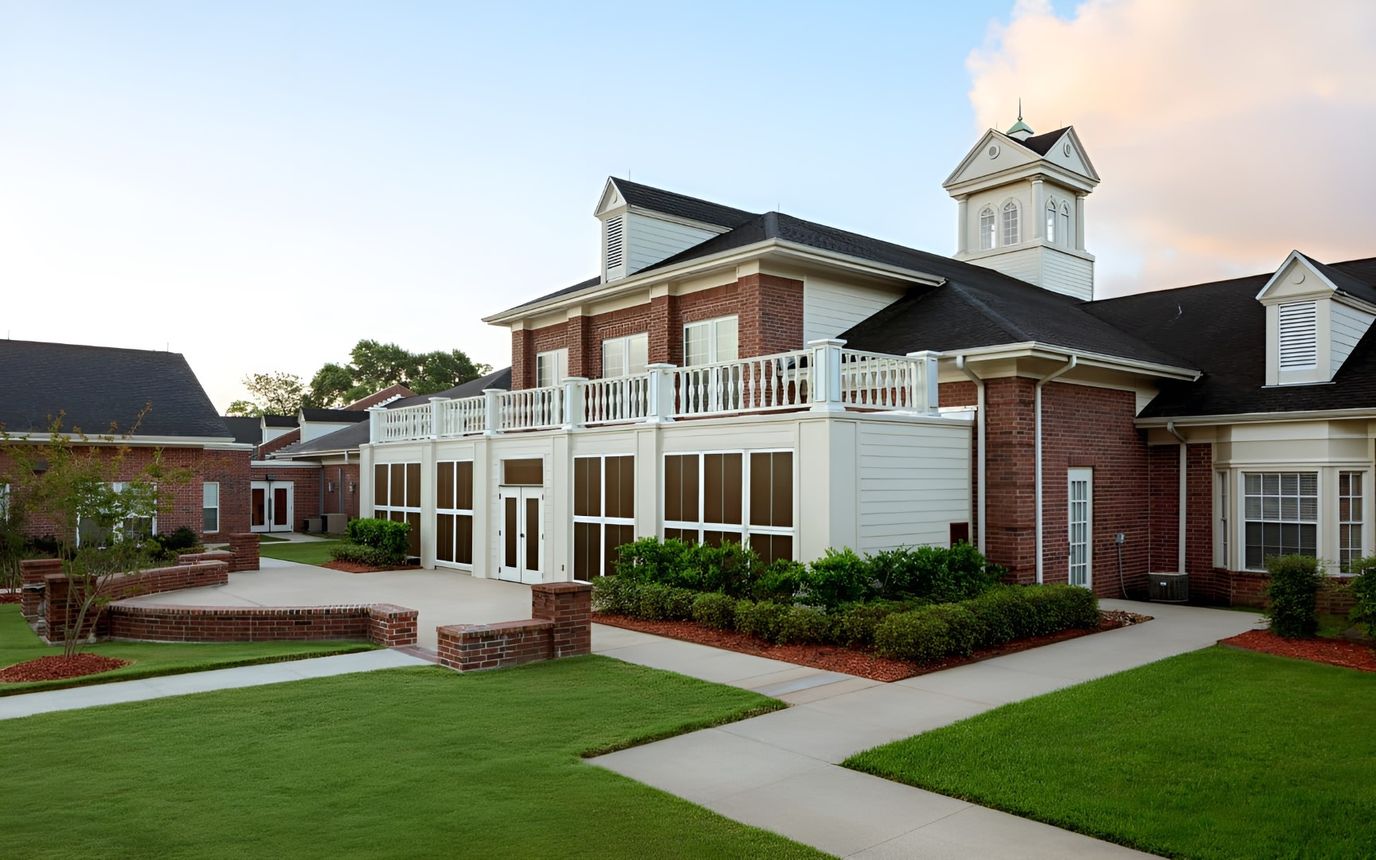 Exterior view of a senior living facility with landscaped grounds