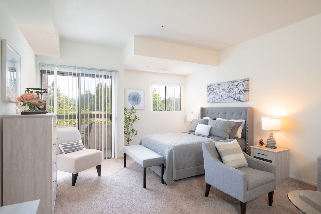 Brightly lit interior of a resident room with furniture