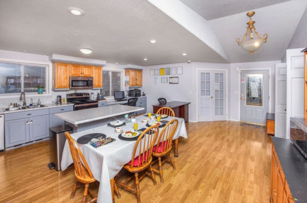 A bright dining room with a table set for meals