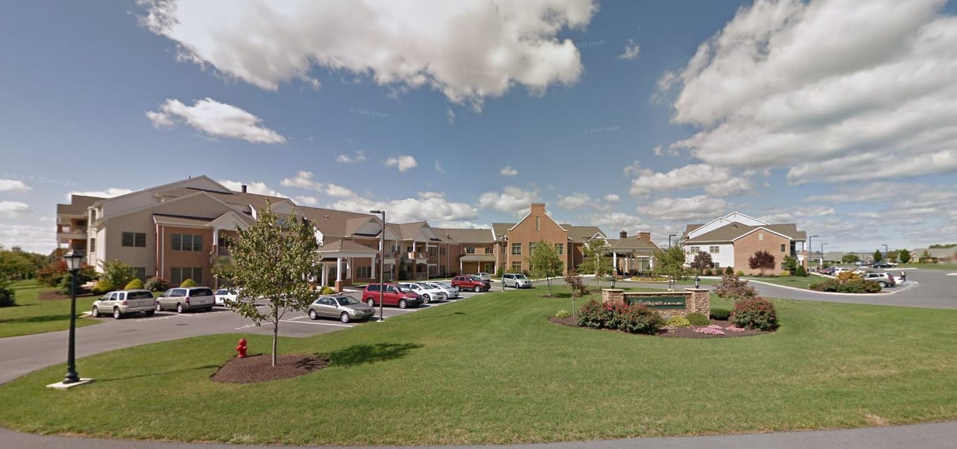 Exterior view of a senior living facility with parking