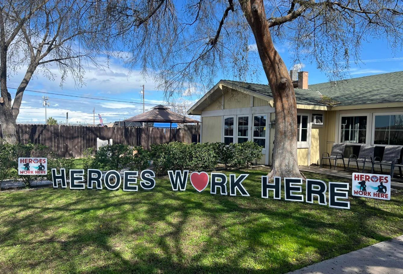 Outdoor sign celebrating staff contributions