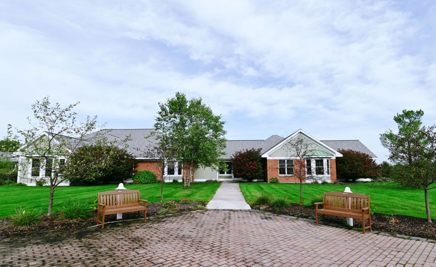 Exterior view of a senior living facility with landscaped grounds