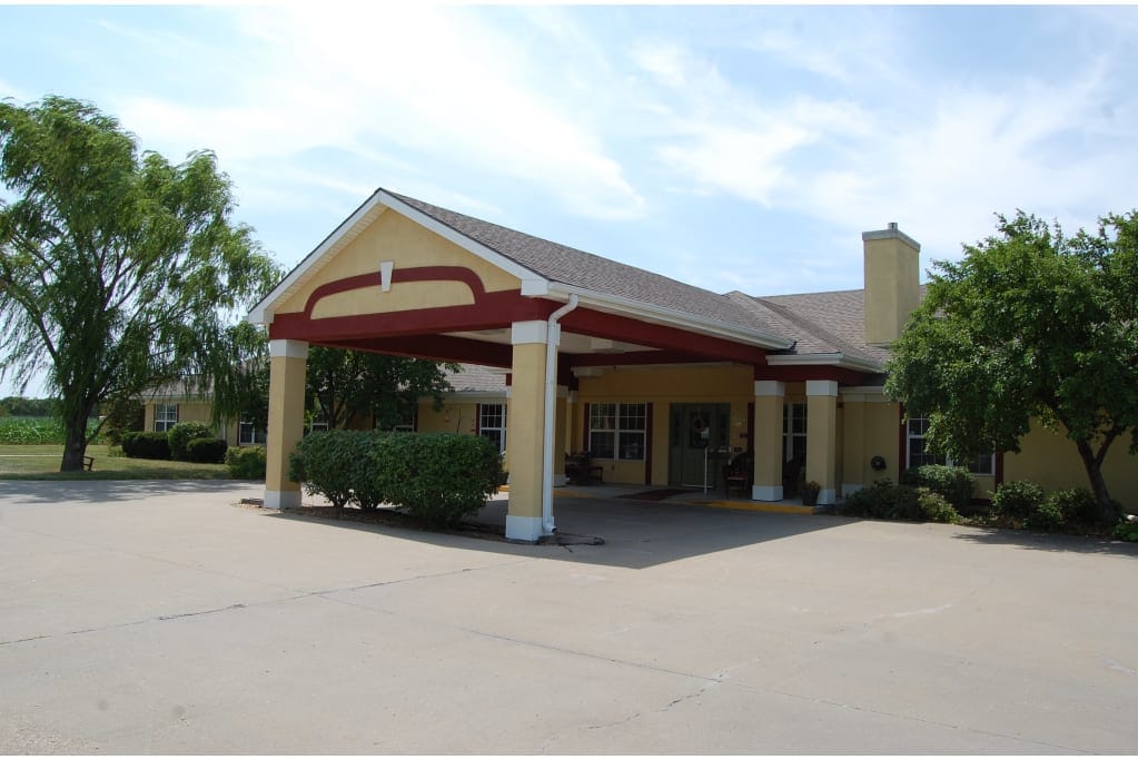 Front entrance of a senior living facility under a covered portico