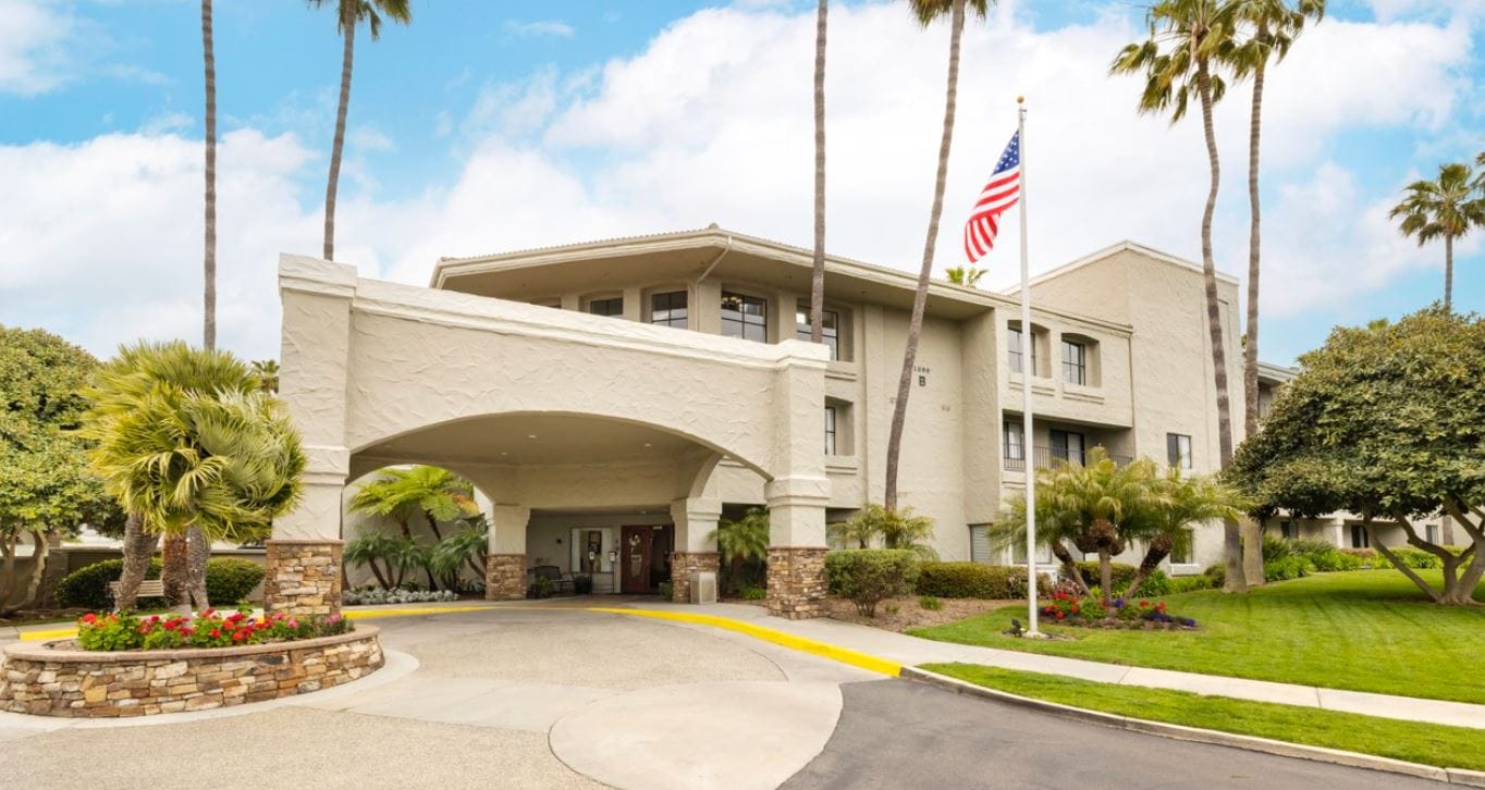 Entrance of Laguna Estates Senior Living facility with palm trees