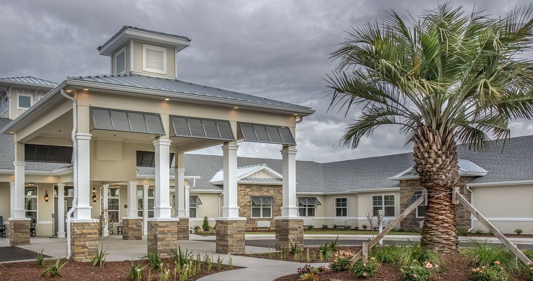 Exterior view of Benton House with palm tree