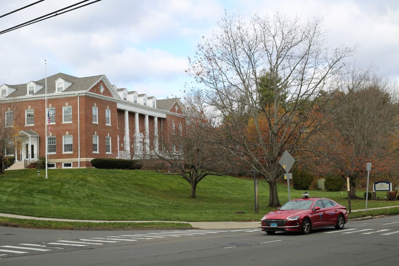 Building exterior of a senior living facility with a car in front