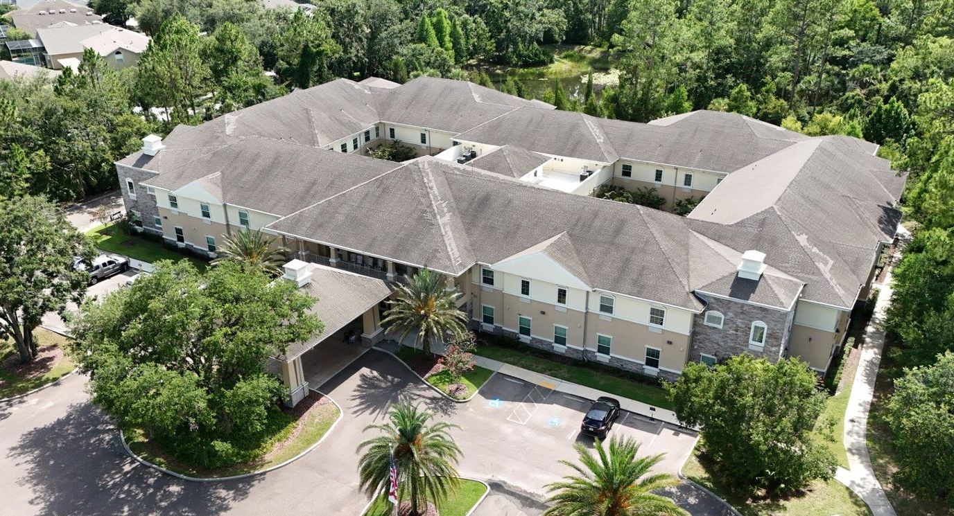 Aerial view of the building and landscaping at The Legacy at Highwoods Preserve