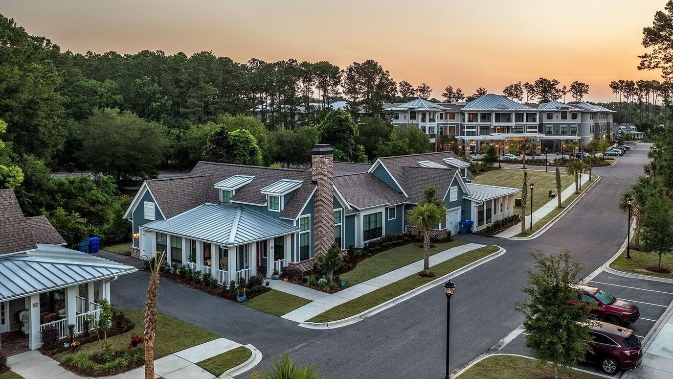 Aerial view of cottages and main building at sunset