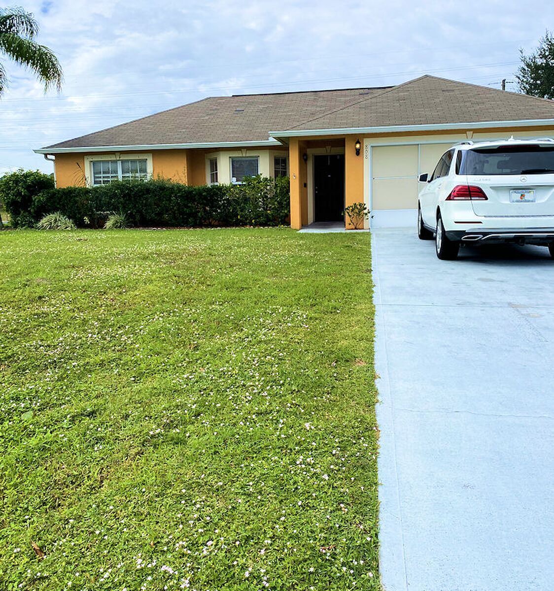 Exterior view of a single-family home with a car