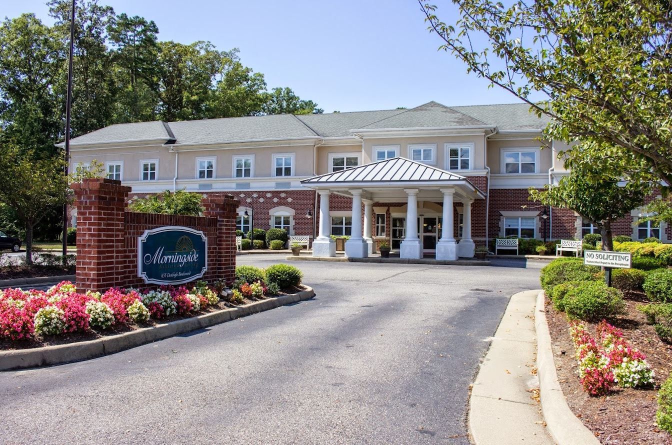 View of the facility exterior with landscaped flower beds