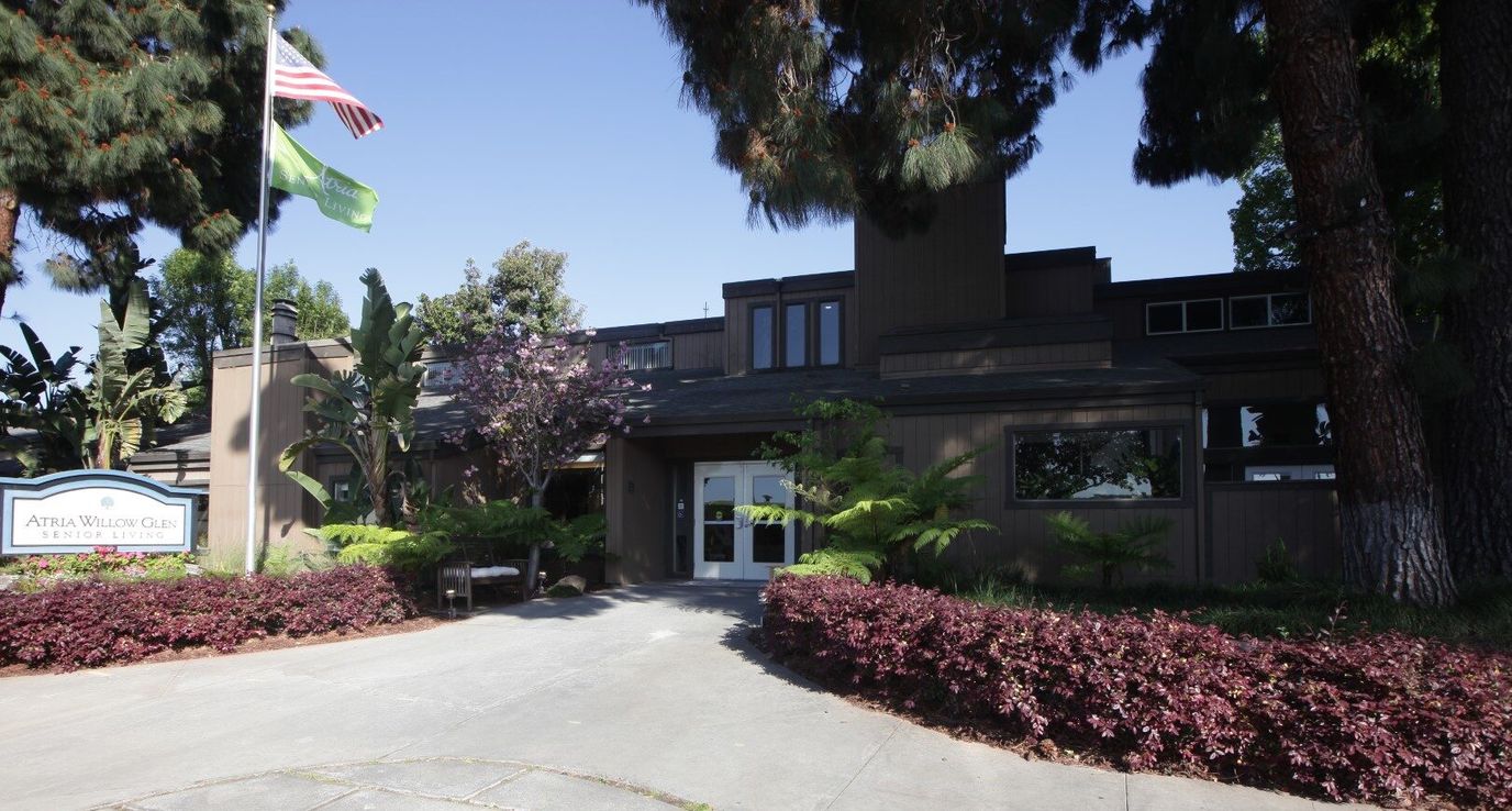 Exterior view of a senior living facility with greenery
