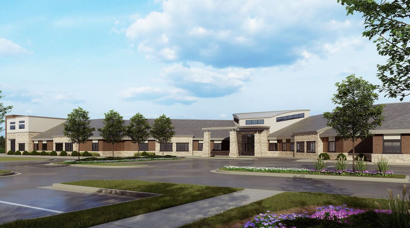 Exterior view of Livonia Comfort Care facility with landscaping