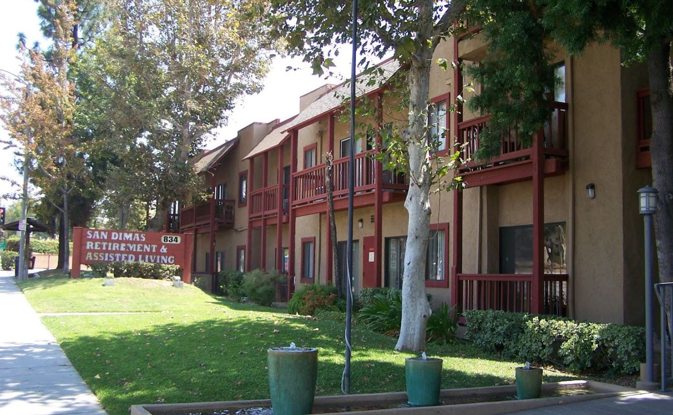 Exterior view of San Dimas Retirement building with sign