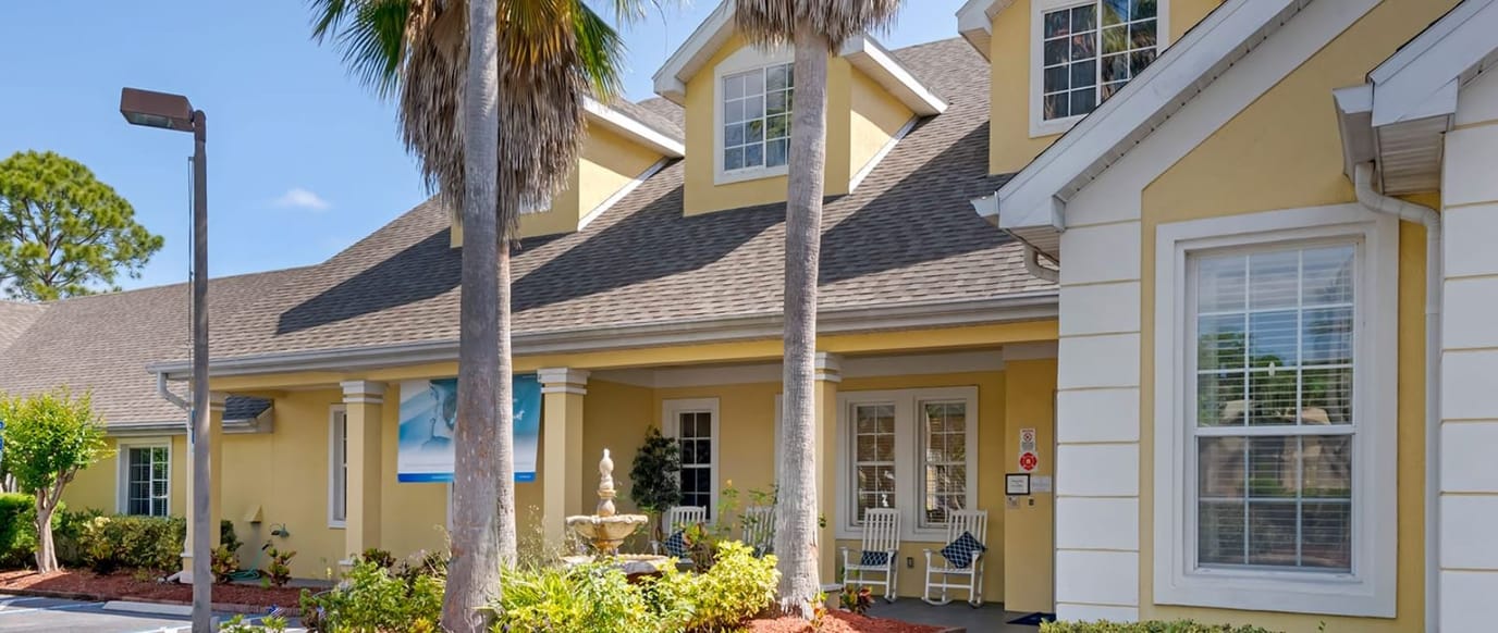 Building exterior with palm trees and entrance
