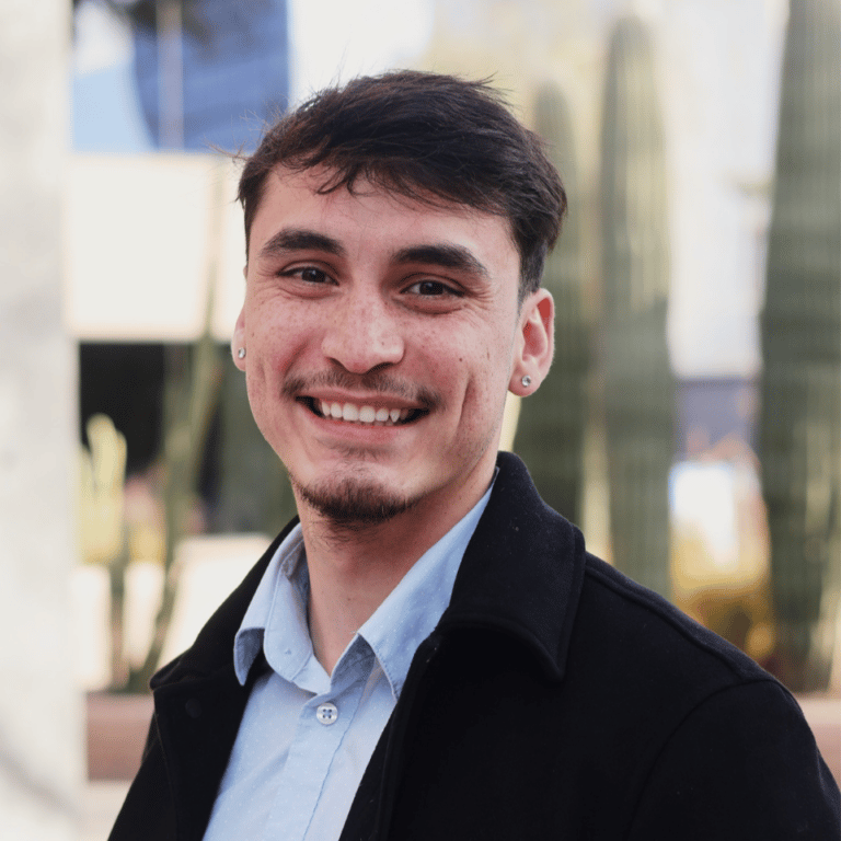 Griswold Home Care for Phoenix, home care in Phoenix, AZ — Smiling young man in front of cacti and building