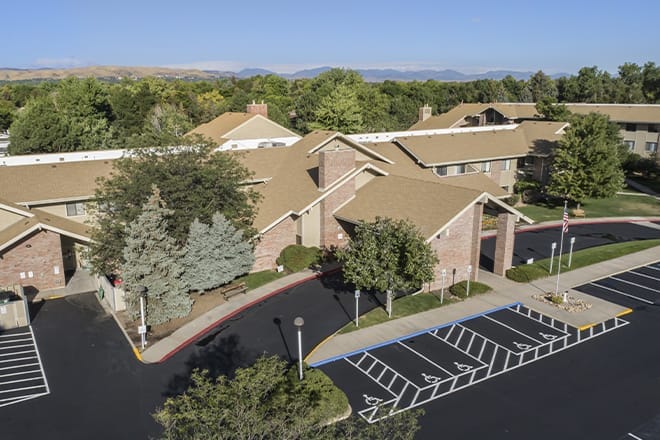 Aerial view of a senior living facility with landscaped grounds
