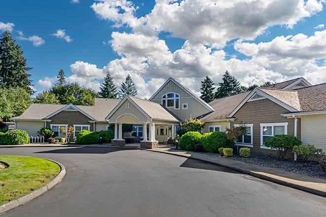 Exterior view of a senior living facility with landscaped entrance