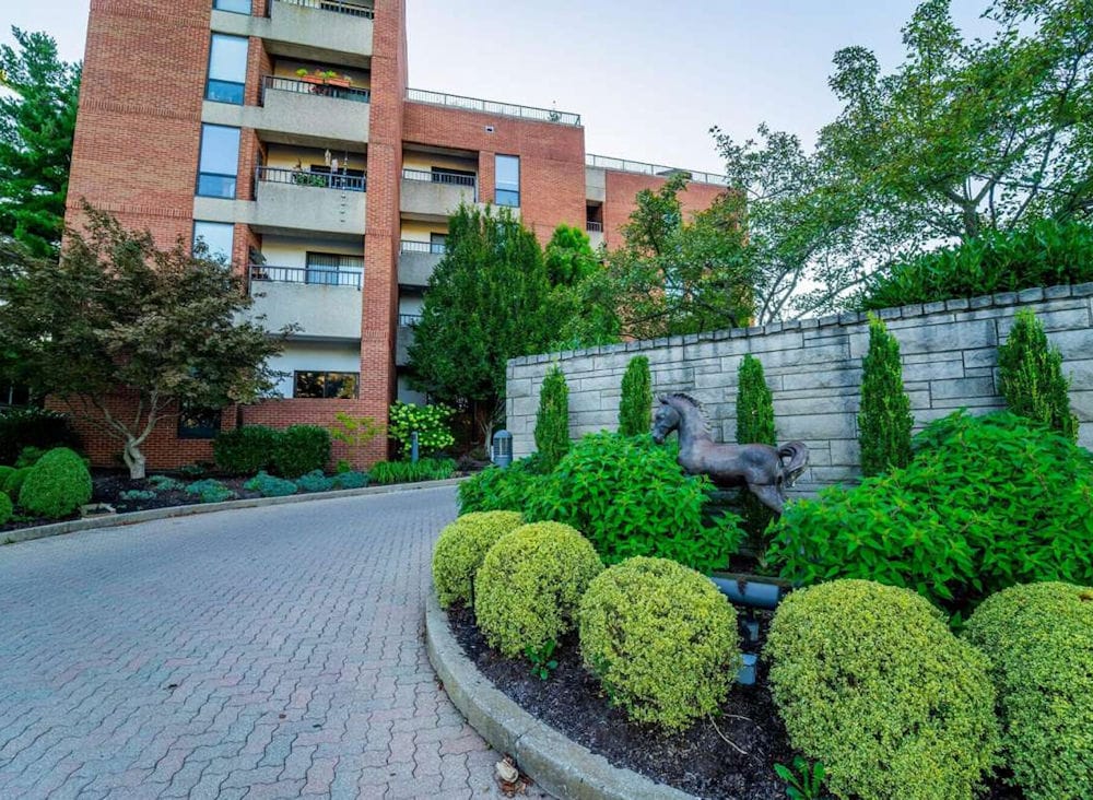 Exterior view of the Mayfair Village Retirement Community with landscaping