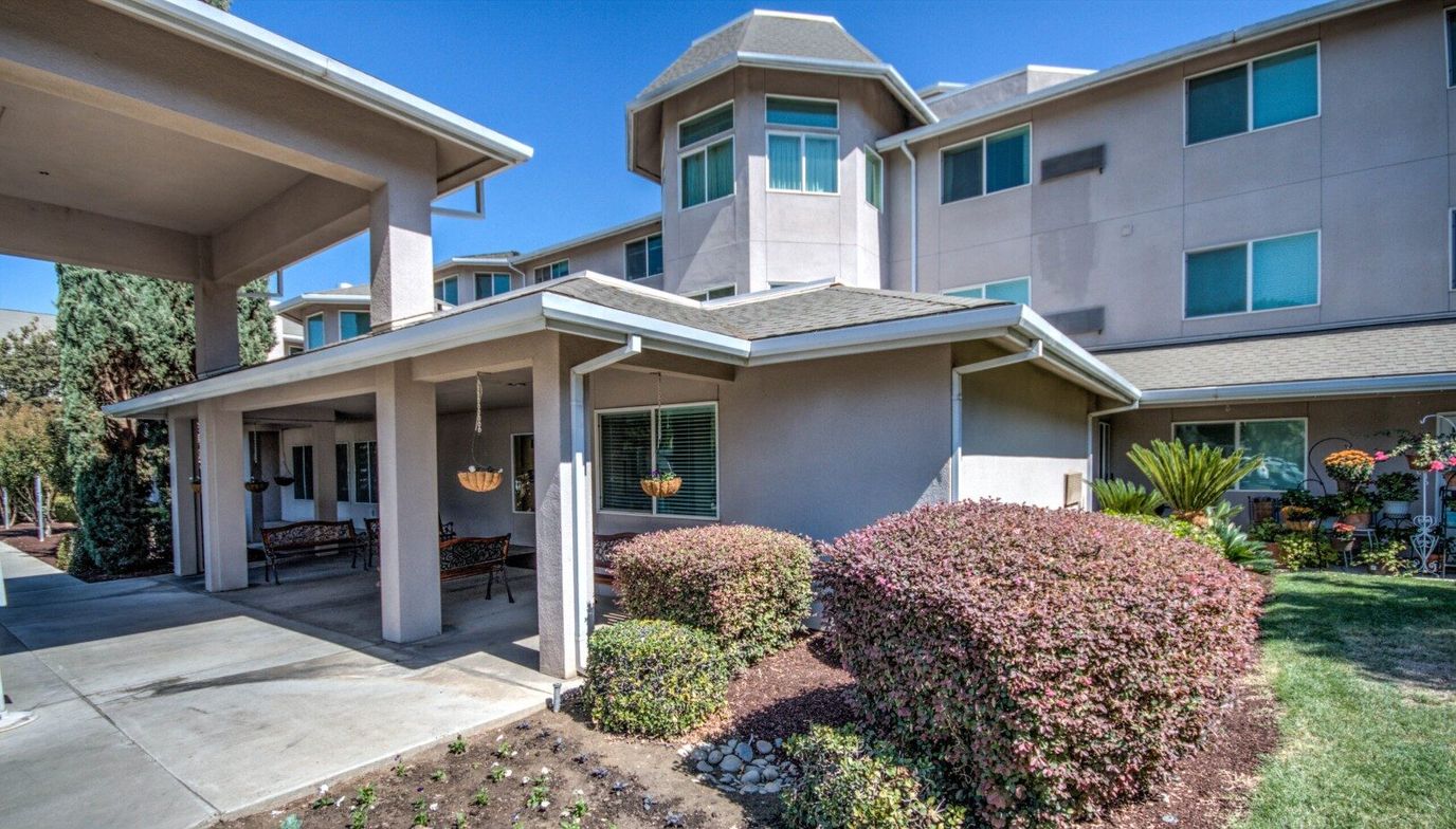 Exterior view of assisted living facility with landscaped garden