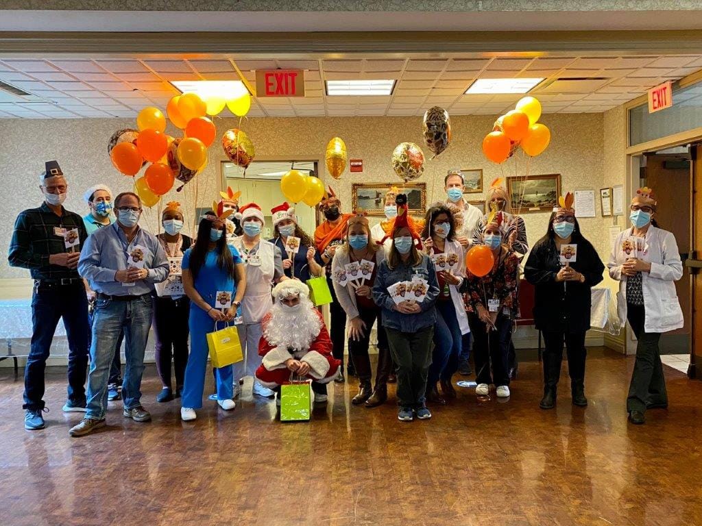 Staff and residents celebrating an event with balloons