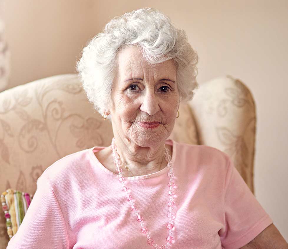 Smiling elderly woman in casual attire