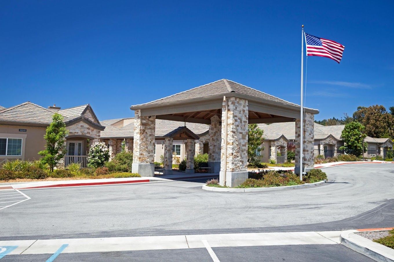 Front entrance of The Cottages of Carmel with American flag