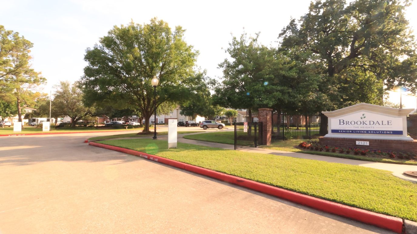 Entrance of Brookdale The Heights with lush greenery