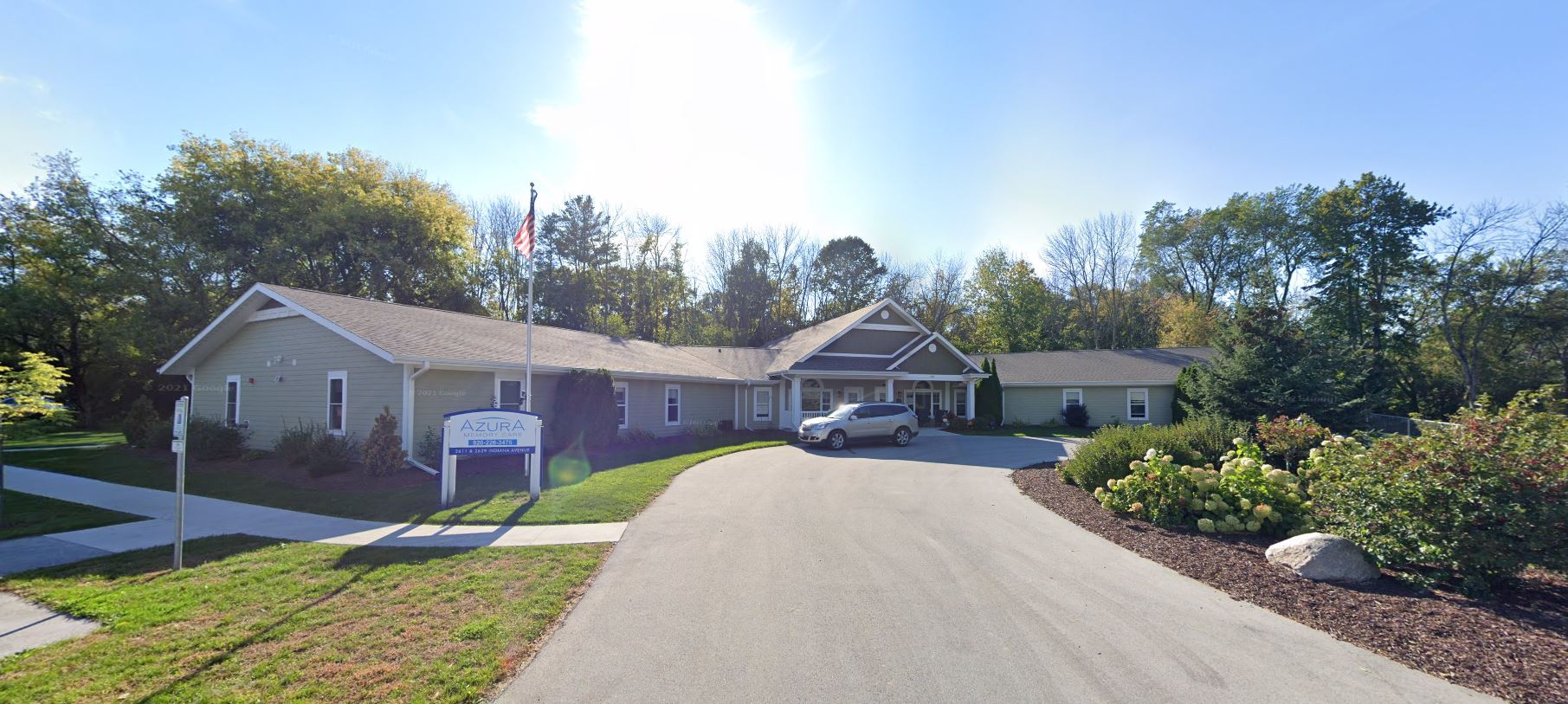 Exterior view of Azura Memory Care facility with landscaped area