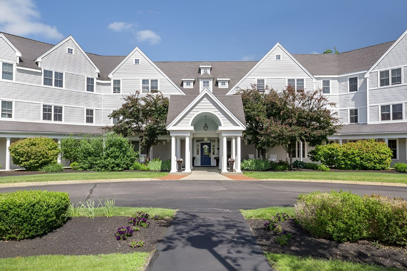 Exterior view of a senior living facility with landscaping
