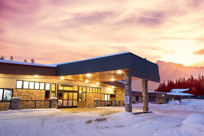 Exterior view of the facility under a colorful sky