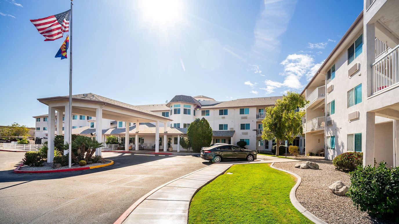 Exterior view of Holiday Desert Rose with flag and landscaping