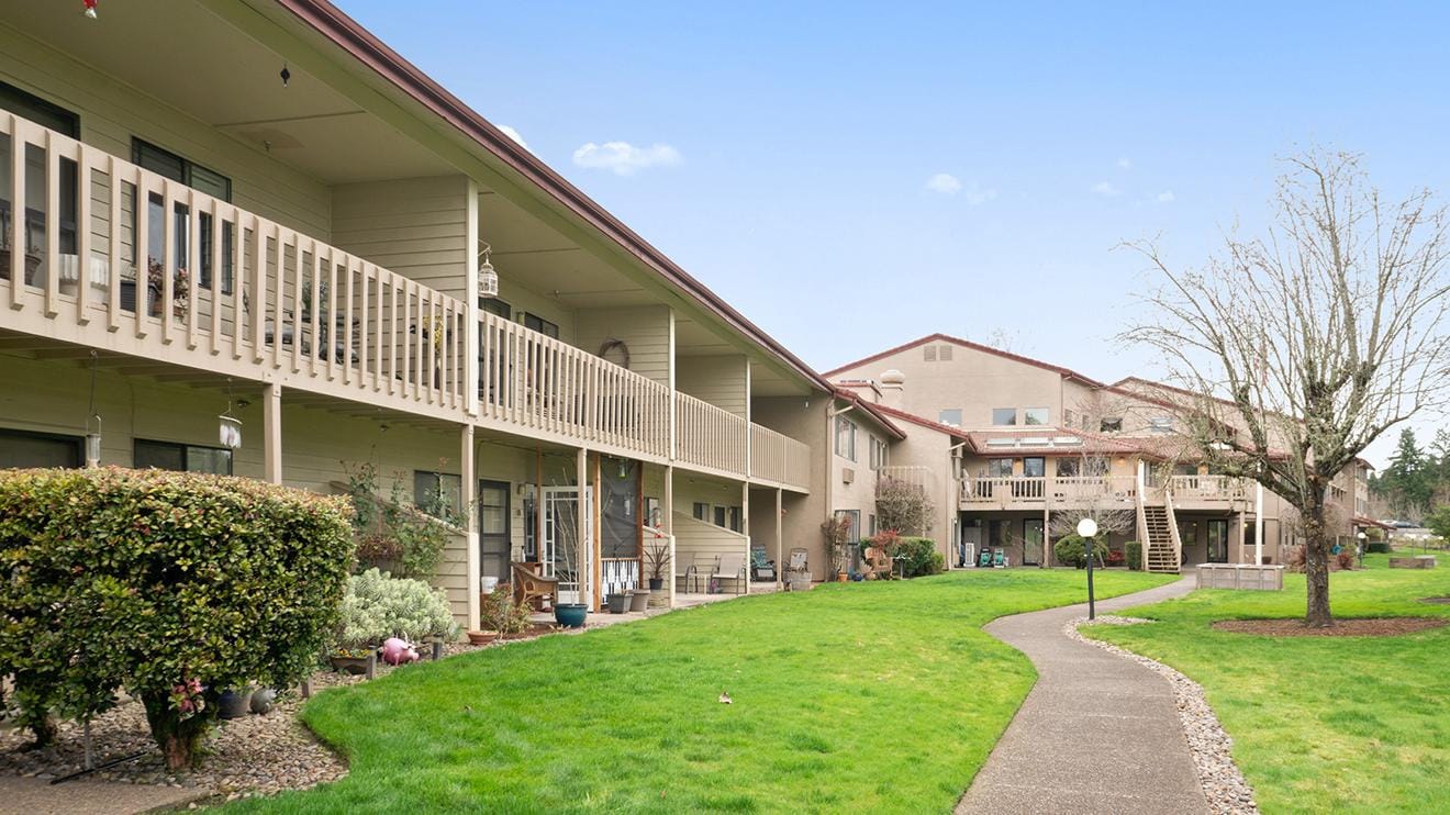 Outdoor view of the assisted living facility with garden paths