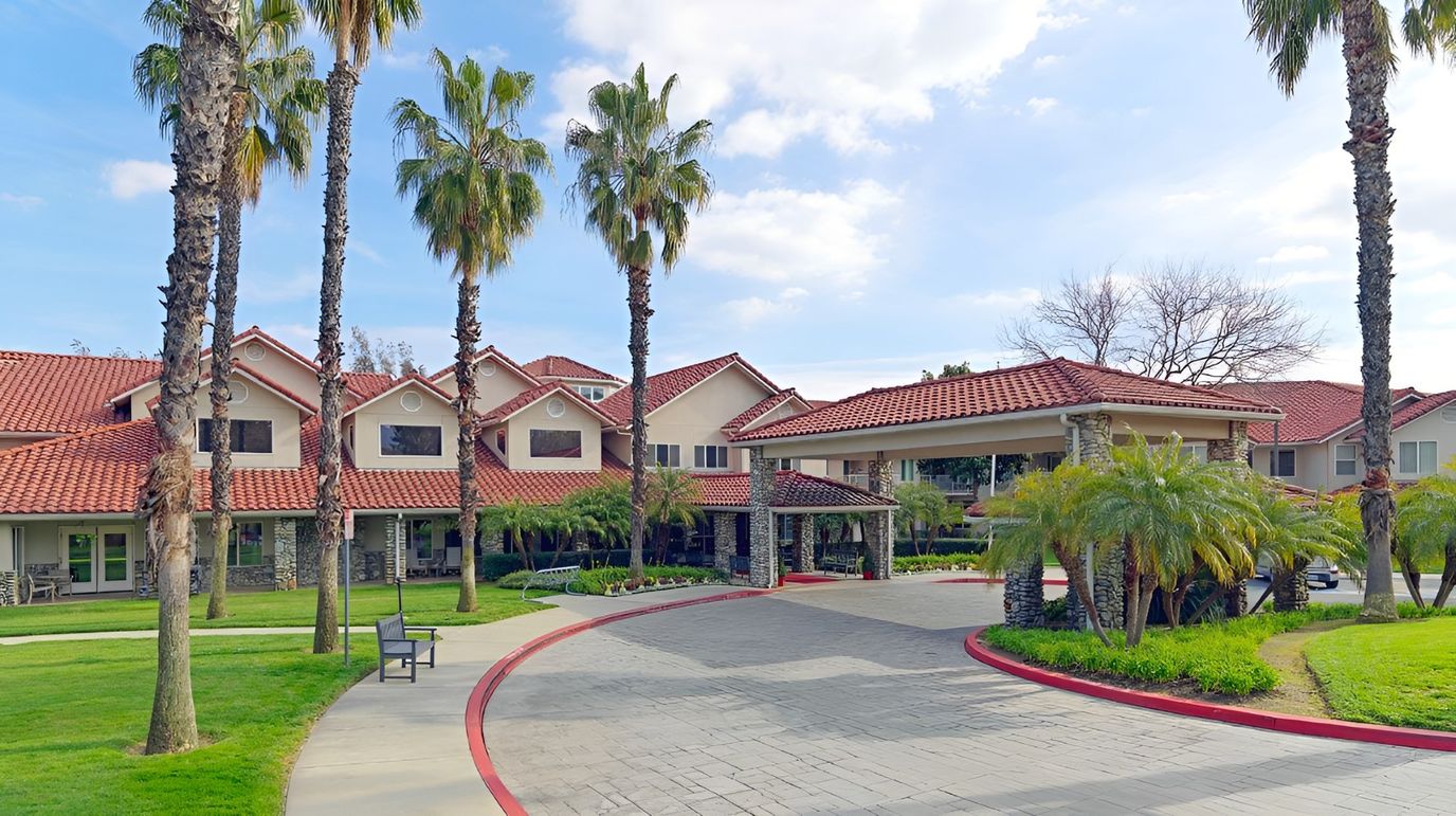 Exterior view of Holiday Valencia Commons with palm trees