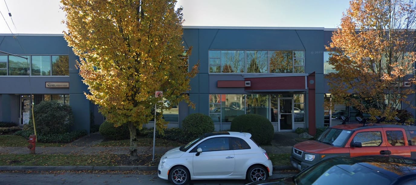 Exterior view of a senior living facility in autumn