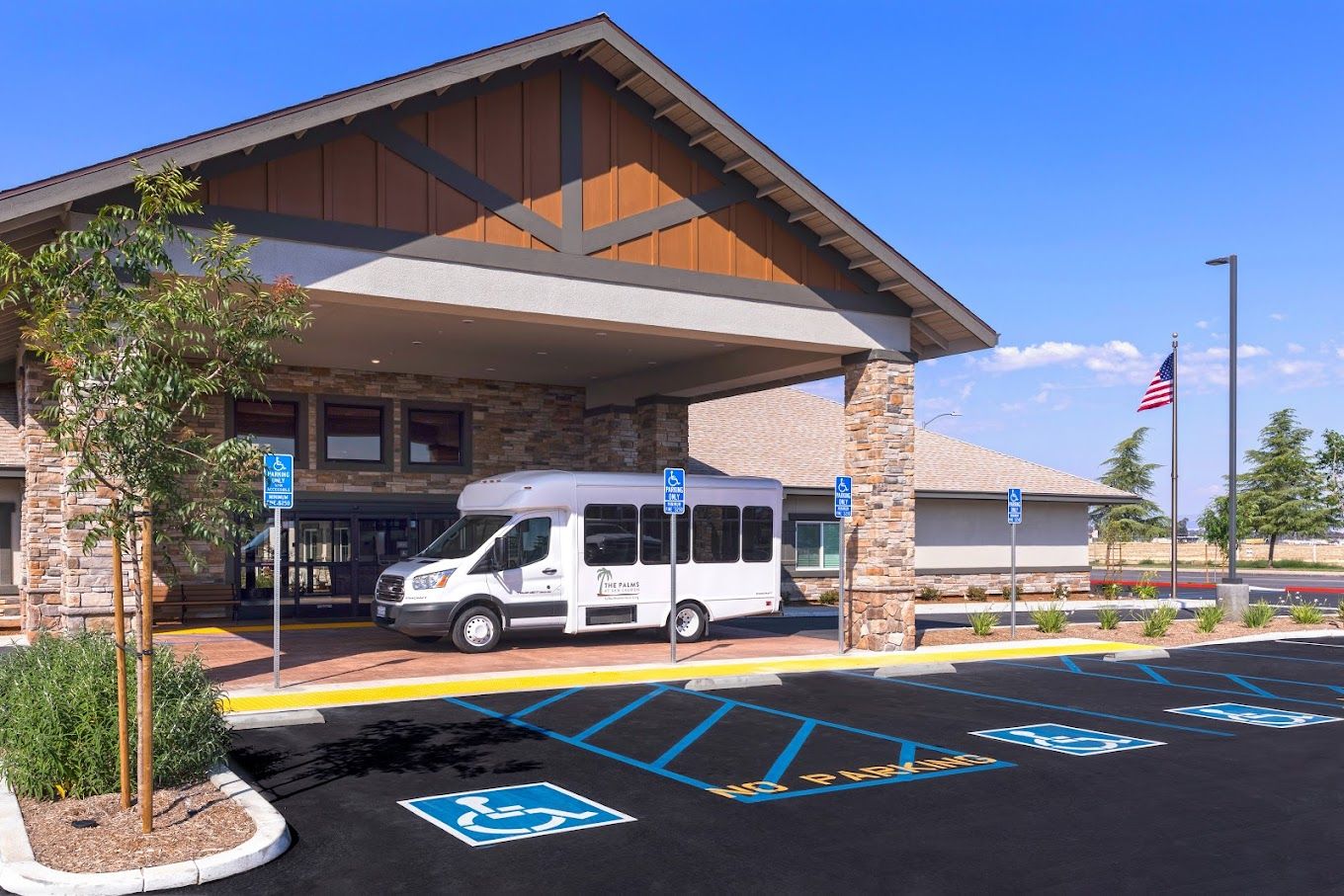Building entrance with shuttle bus and accessible parking