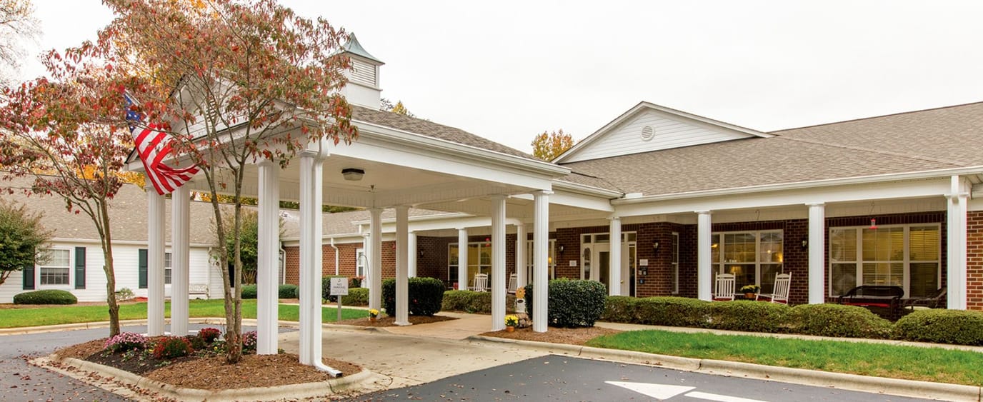 Front entrance of a senior living facility with landscaping