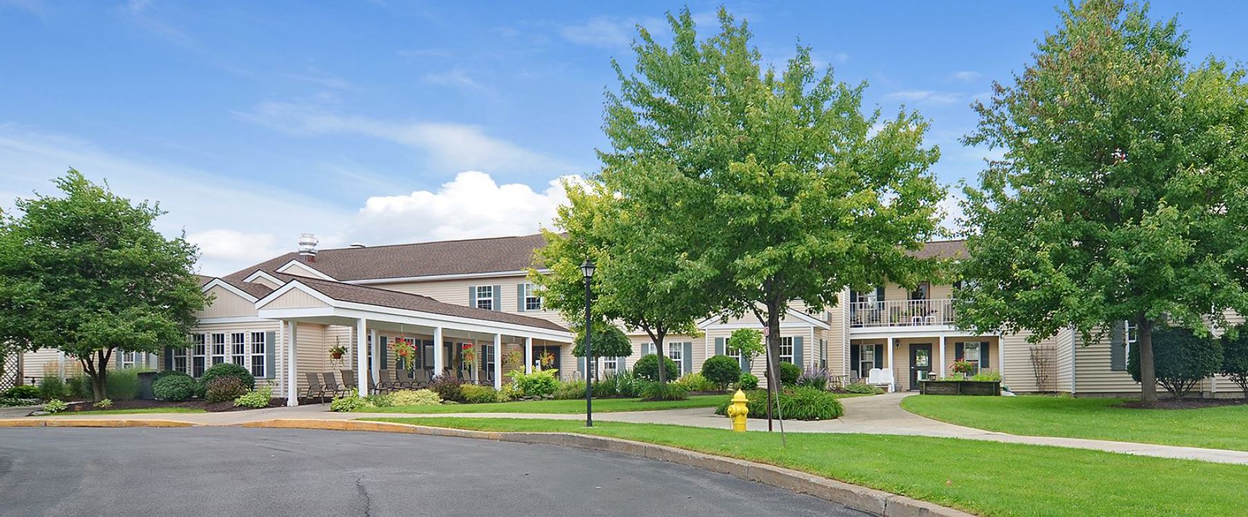 Exterior view of a senior living facility with landscaping
