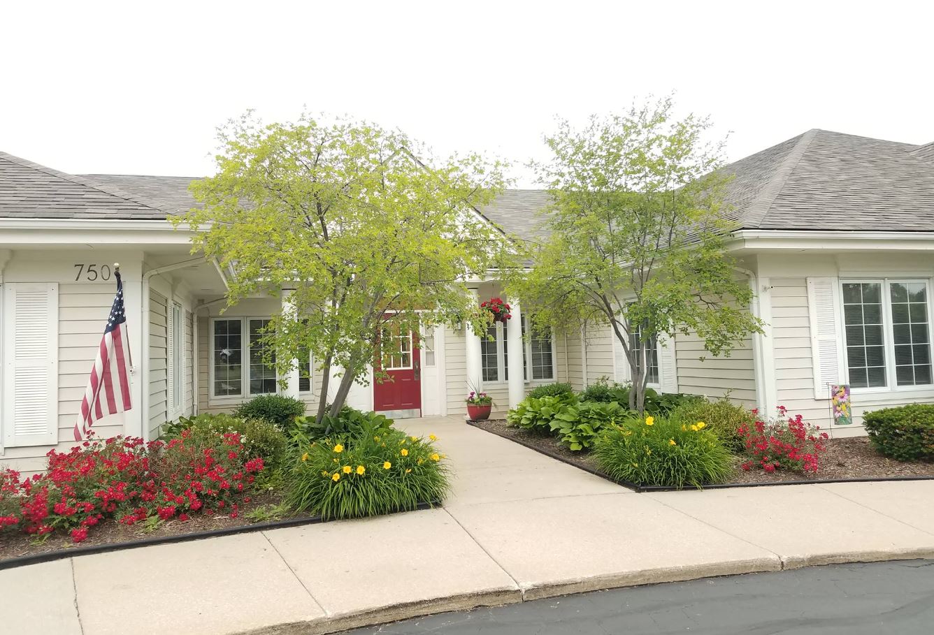 Front entrance of a senior living facility with landscaping