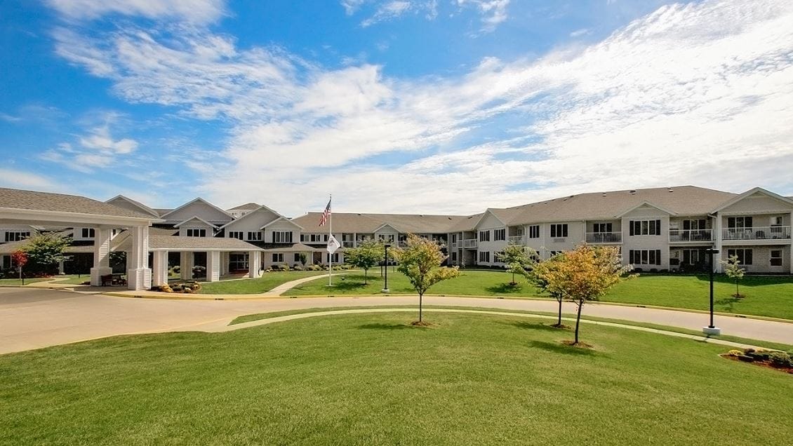 Exterior view of a senior living facility with landscaped grounds
