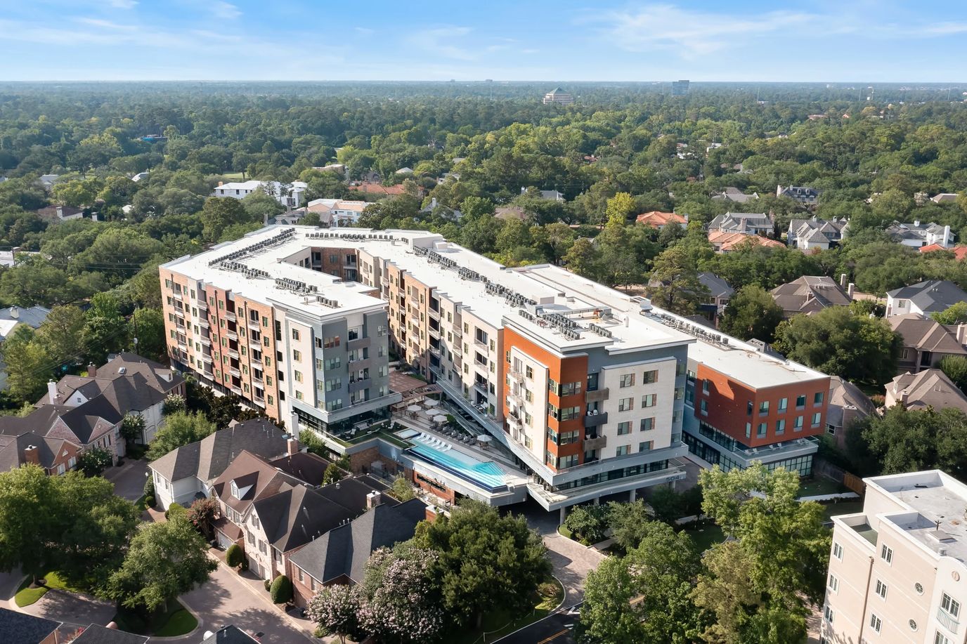 Aerial view of assisted living facility surrounded by greenery