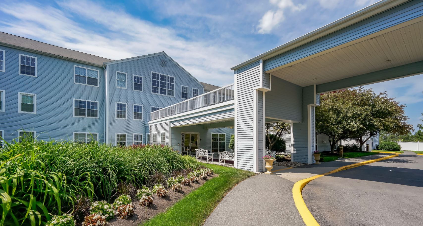 Exterior view of a senior living facility with gardens